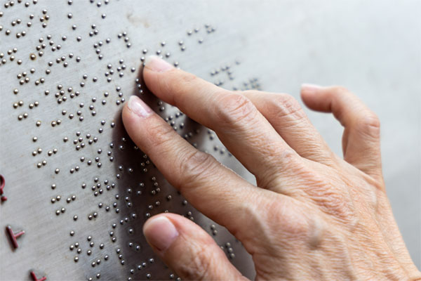 blind person reading braille