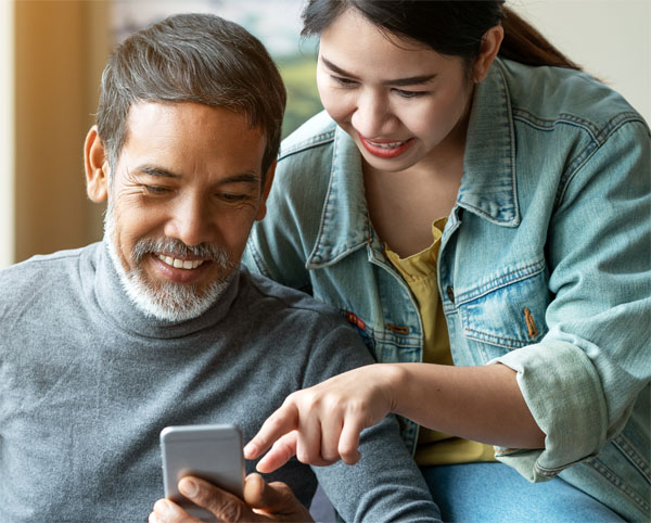 happy people looking at a phone together